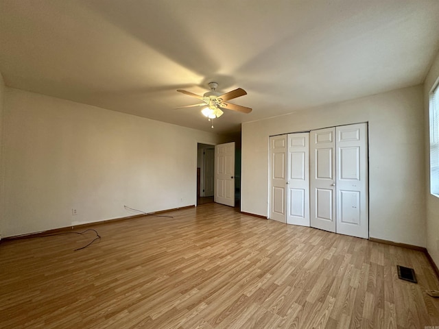 unfurnished bedroom with ceiling fan, light hardwood / wood-style floors, and a closet