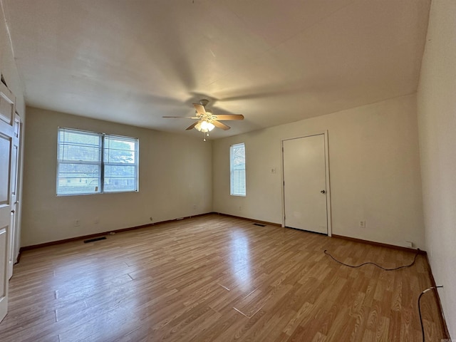 empty room featuring ceiling fan and light hardwood / wood-style floors