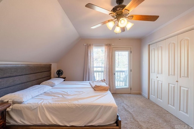 bedroom featuring ceiling fan, lofted ceiling, light carpet, and a closet