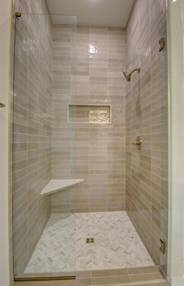 bathroom featuring a shower with shower door