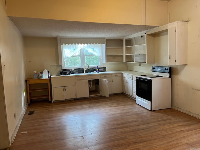 kitchen with a textured ceiling, sink, electric stove, light hardwood / wood-style flooring, and white cabinets