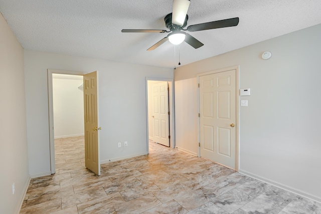 unfurnished bedroom featuring a textured ceiling and ceiling fan