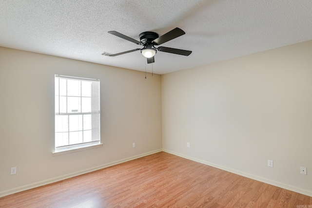 unfurnished room featuring a textured ceiling, light hardwood / wood-style flooring, and ceiling fan