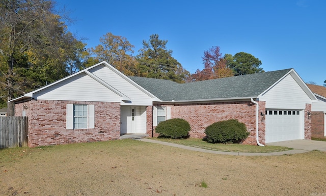 ranch-style home featuring a garage and a front yard