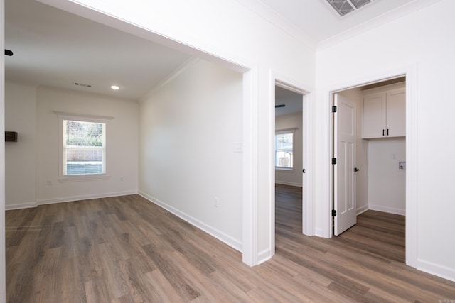 empty room featuring dark hardwood / wood-style floors and ornamental molding