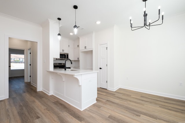 kitchen featuring a breakfast bar area, light hardwood / wood-style flooring, white cabinets, and pendant lighting