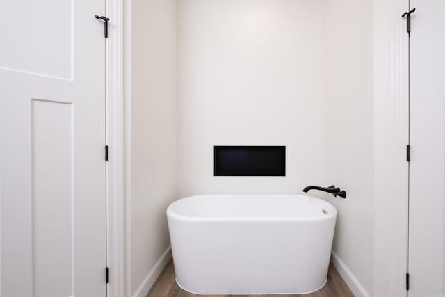 bathroom featuring a tub and wood-type flooring