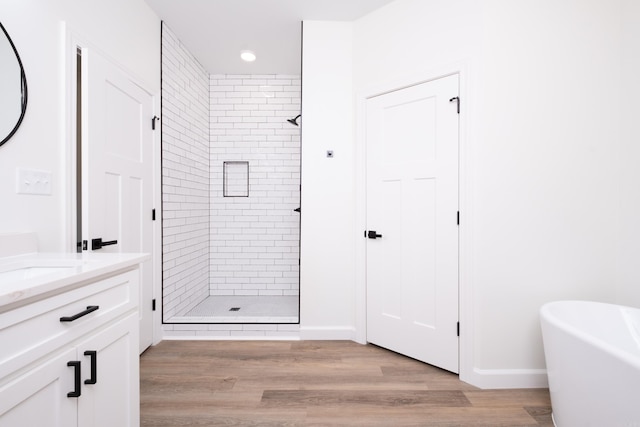 bathroom featuring wood-type flooring, vanity, and independent shower and bath