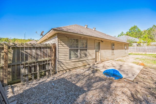 back of property with a patio