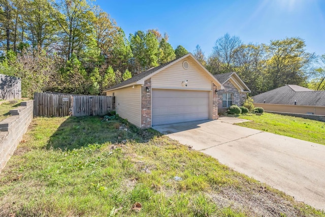 view of side of property featuring a yard and a garage