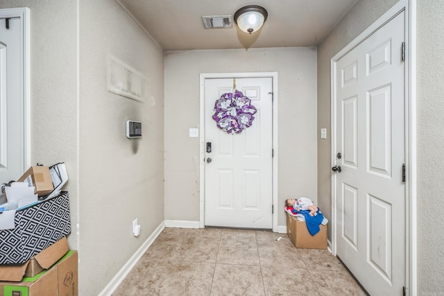 entrance foyer with light tile patterned flooring