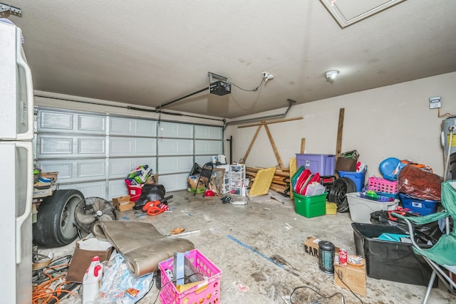 garage featuring white fridge, electric water heater, and a garage door opener