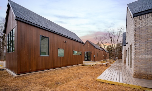 property exterior at dusk with a deck