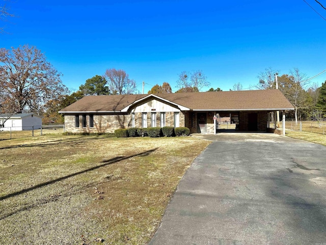 single story home with a front yard and a carport