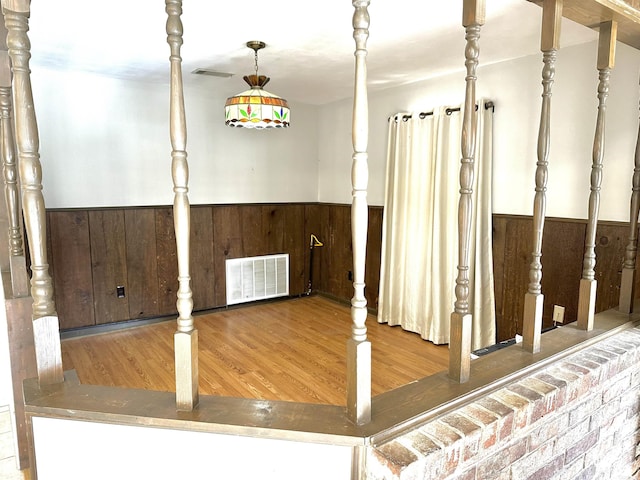 interior space featuring hardwood / wood-style floors and wood walls