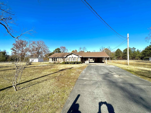 single story home featuring a front yard and a carport