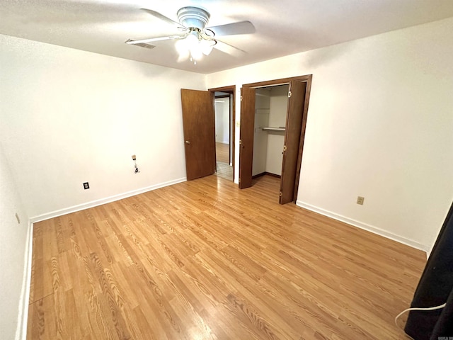 unfurnished bedroom featuring a closet, light hardwood / wood-style floors, and ceiling fan