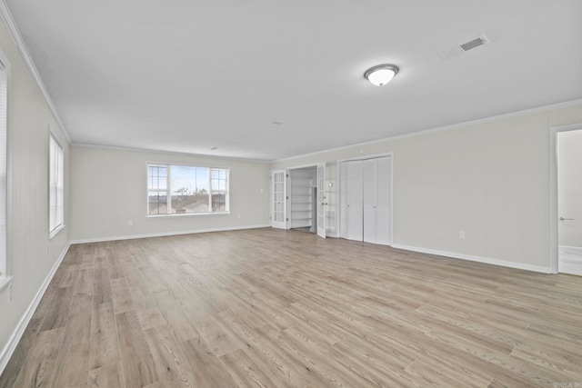 interior space with light hardwood / wood-style flooring and ornamental molding