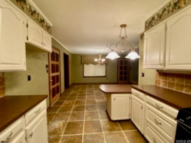 kitchen featuring pendant lighting, white range oven, white cabinetry, and a chandelier