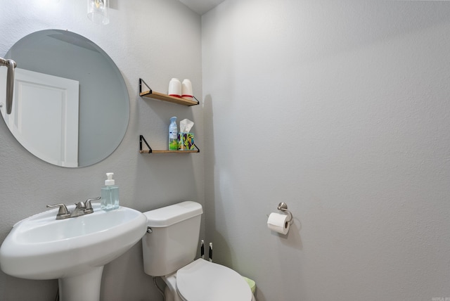 bathroom featuring toilet and sink