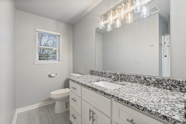 bathroom featuring vanity and toilet