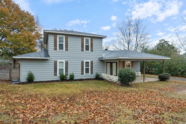 rear view of house with a yard and french doors