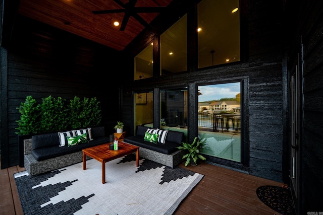 wooden deck featuring an outdoor living space and ceiling fan