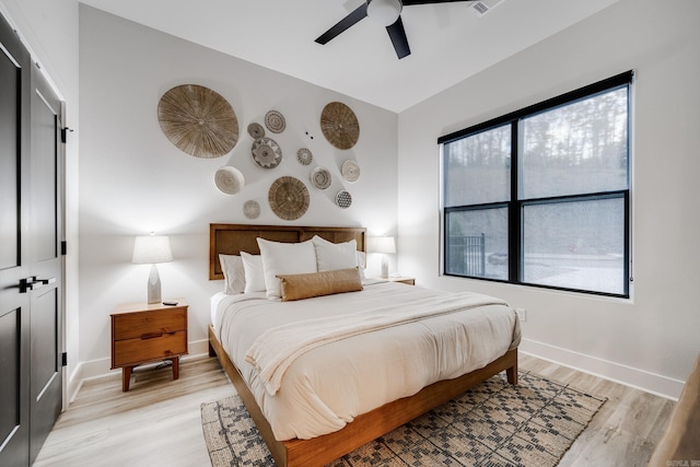 bedroom with a closet, ceiling fan, and light hardwood / wood-style flooring