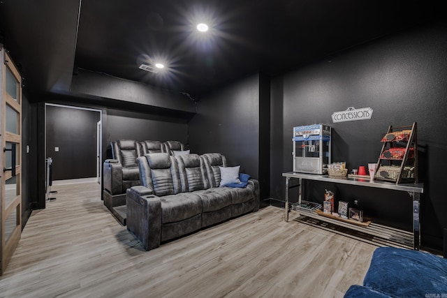 home theater room with light hardwood / wood-style floors