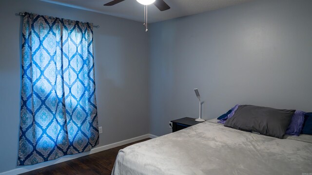 bedroom featuring ceiling fan and dark wood-type flooring