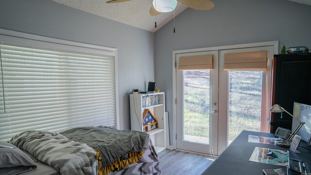 bedroom featuring access to exterior, ceiling fan, light hardwood / wood-style floors, a textured ceiling, and vaulted ceiling