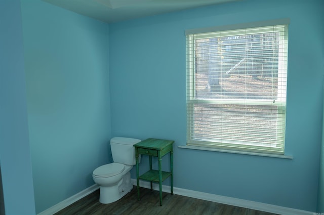 bathroom featuring hardwood / wood-style floors and toilet