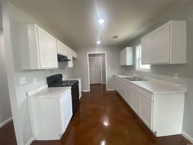 kitchen featuring electric range, light stone counters, white cabinetry, and sink