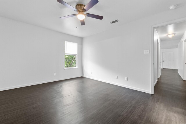 spare room featuring ceiling fan and dark hardwood / wood-style flooring