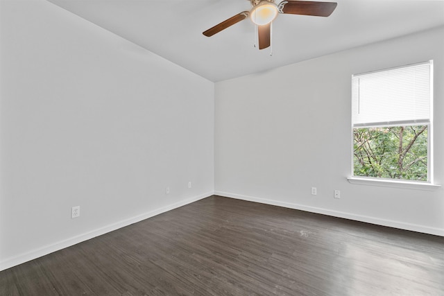 spare room with ceiling fan and dark wood-type flooring