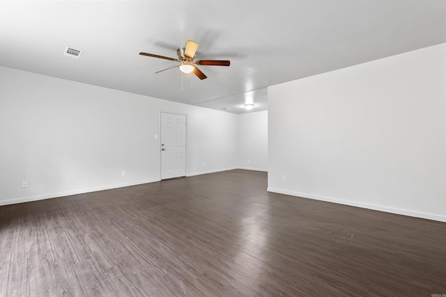 spare room with ceiling fan and dark hardwood / wood-style floors