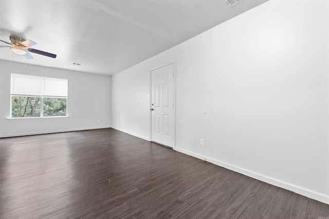 spare room featuring ceiling fan and dark wood-type flooring