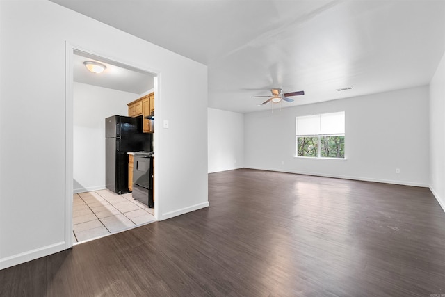 unfurnished living room with ceiling fan and light wood-type flooring