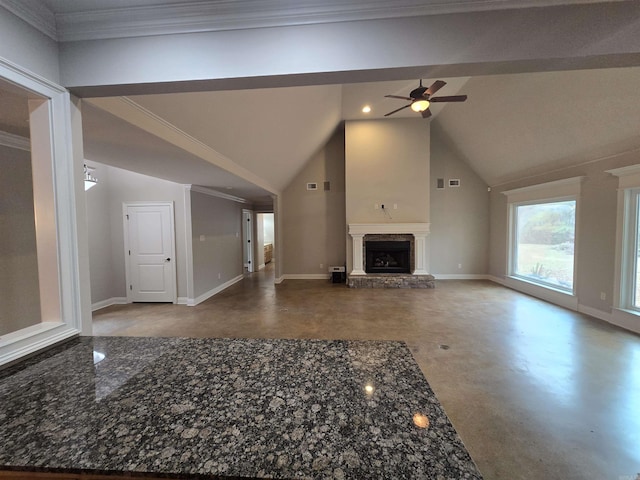 unfurnished living room featuring ceiling fan, concrete floors, vaulted ceiling, and ornamental molding