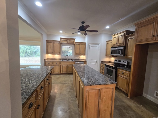 kitchen featuring a kitchen island, ornamental molding, sink, and appliances with stainless steel finishes