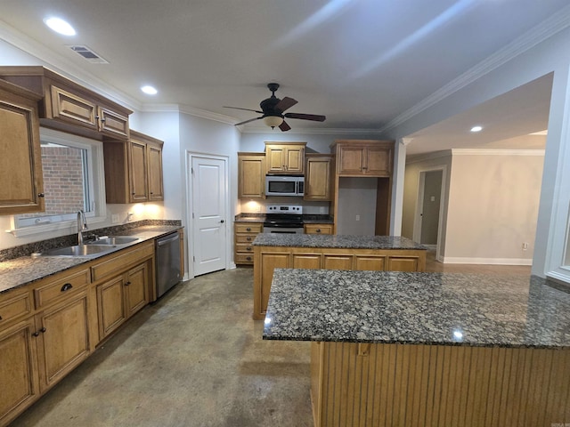 kitchen featuring ceiling fan, sink, a center island, appliances with stainless steel finishes, and ornamental molding