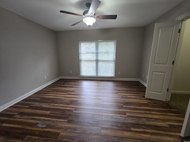 empty room with ceiling fan and dark hardwood / wood-style flooring