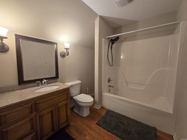 full bathroom featuring vanity, hardwood / wood-style floors, shower / bathing tub combination, and toilet