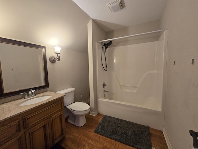 full bathroom with vanity, hardwood / wood-style flooring, toilet, and tub / shower combination