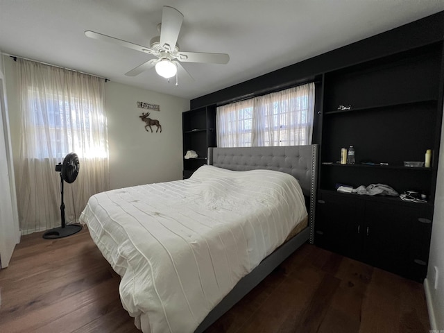 bedroom featuring ceiling fan and dark wood-type flooring