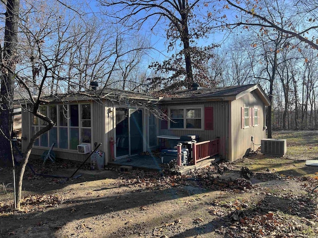 back of house featuring cooling unit and a sunroom