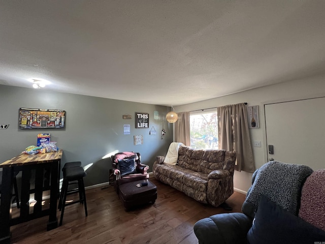 living room with dark hardwood / wood-style flooring and a textured ceiling