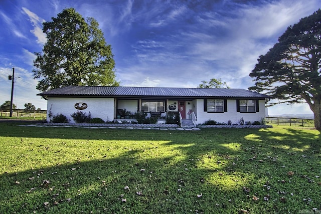 ranch-style home with a front lawn