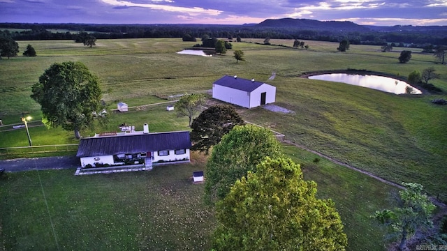 aerial view at dusk with a rural view and a water and mountain view