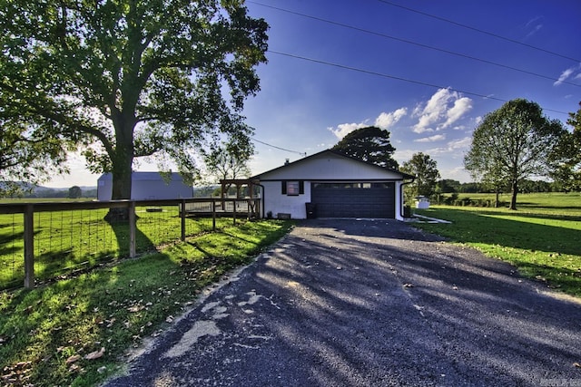 view of front facade with an outbuilding, a front yard, and a garage